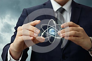 Atom shows in the hands of the businessman .