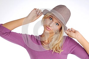 Atractive blonde woman with hat in violet sweater