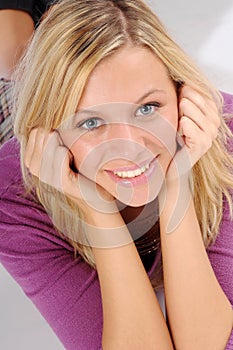 Atractive blonde woman in violet sweater