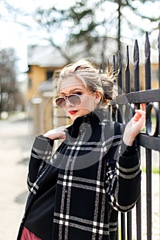 Atractive girl in black coat and sunglasses