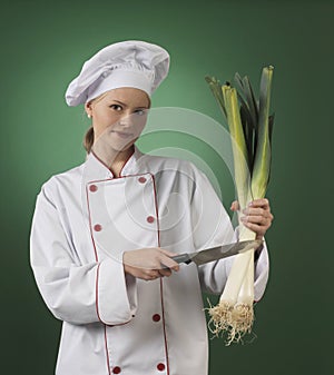Atractive professional cook on green background