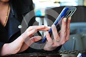 Atractive woman typing on a smartphone