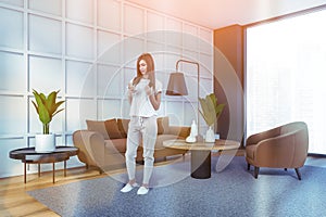 Atractive woman wearing white t-shirt is chating in living room