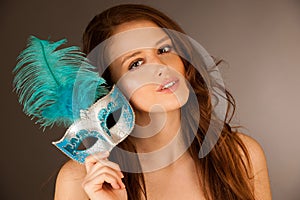 Atractive young woman with venice mask studio portrait