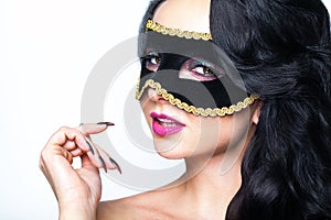 Atractive young woman with venice mask studio portrait
