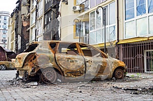 Atrocities of the russian army in the suburbs of Kyiv. Automobile and houses in of civilians destroyed by russian weapons.