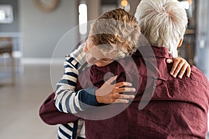 Attached child hugging his grandfather photo