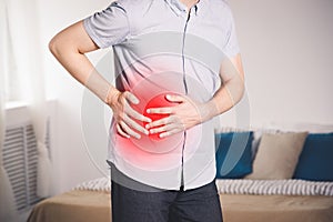 Attack of appendicitis, man with abdominal pain suffering at home