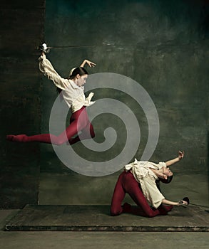Two young female ballet dancers like duelists with swords. Ballet and contemporary choreography concept. Creative art photo