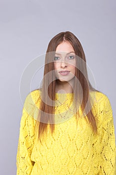 Attactive red haired woman with yellow pullover