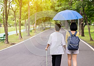 Attempt elderly asian woman walking to do workout with stick at public park,Daughter take care and support