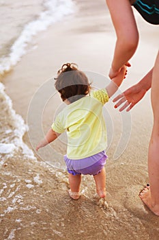 Attending baby on sea shore