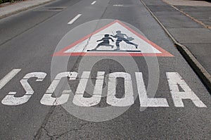 Attention children crossing for school sign drawn on the street