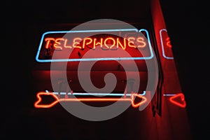 Attention getting neon sign with arrow for telephone