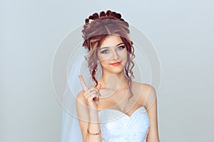 Attention listen to me. Close up portrait of young bride spouse woman showing attention be careful hand gesture isolated on light