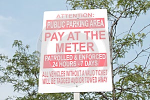 attention public parking area pay at the meter patrolled and enforced 24 hours