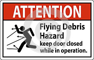 Attention sign indicating the risk of flying debris, advising to keep the door closed