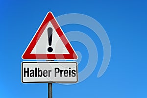 Attention and warning sign with blue sky and german text HALBER PREIS - translation: half price photo