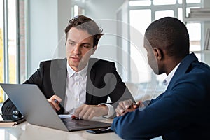 Attentive African American businessman wearing formal suit talki