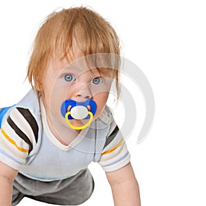 Attentive baby with a pacifier