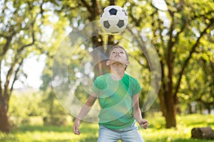 Attentive boy looking at soccer ball up in air