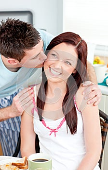 Attentive boyfriend kissing his girlfriend