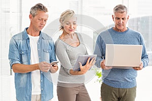 Attentive business colleagues using electronic devices