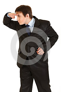 Attentive businessman holding hand at forehead
