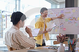 Attentive businessman listening intently to his colleague during explaining new project in meeting.