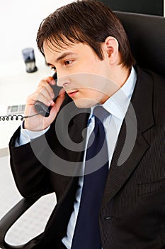 Attentive businessman talking on telephone