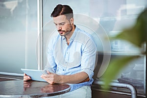 Attentive businessman using a tablet