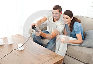 Attentive couple playing video game together