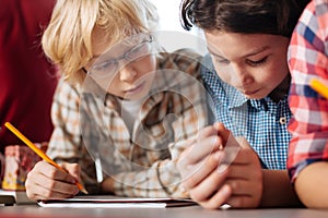 Attentive curious kids reading the assignment