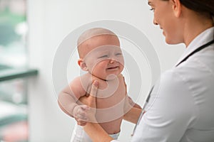 Attentive doctor examining a frightened pediatric patient