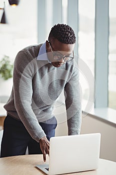 Attentive executive using laptop at desk