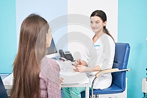 Attentive friendly professional physician receiving female client