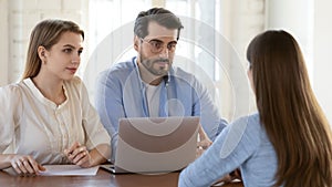 Attentive male and female employers interviewing candidate on vacant place