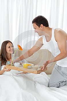 Attentive man bringing the breakfast to his wife