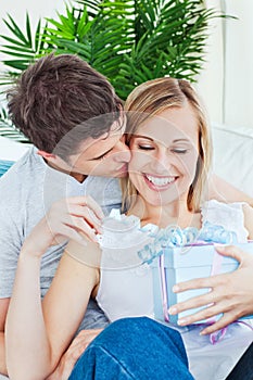 Attentive man giving his girlfriend a present