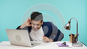 Attentive man in suit holding hand near ear, trying to hear his opponent, problems with hearing, deafness