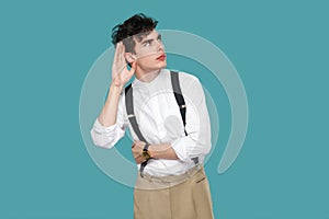 Attentive man trying to hear with hand near ears