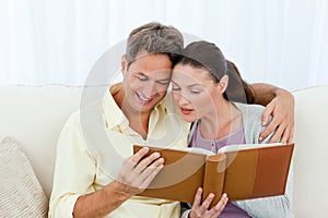 Attentive man and woman looking at a photo album