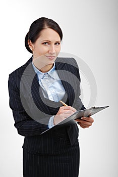 Attentive office worker writing in the folder.