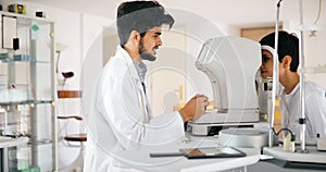 Attentive optometrist examining female patient on slit lamp