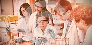 Attentive school kids doing a chemical experiment in laboratory