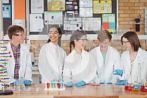 Attentive school kids doing a chemical experiment in laboratory