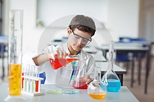 Attentive schoolboy doing a chemical experiment in laboratory