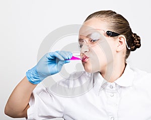Attentive schoolgirl conducting a chemistry experiment at elementary science class