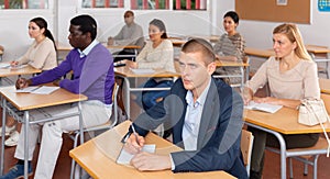 Attentive students at their desks in university auditorium