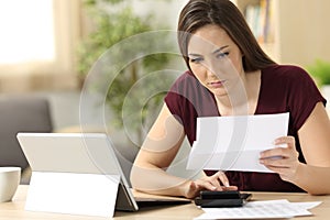 Attentive woman calculating accountancy at home photo